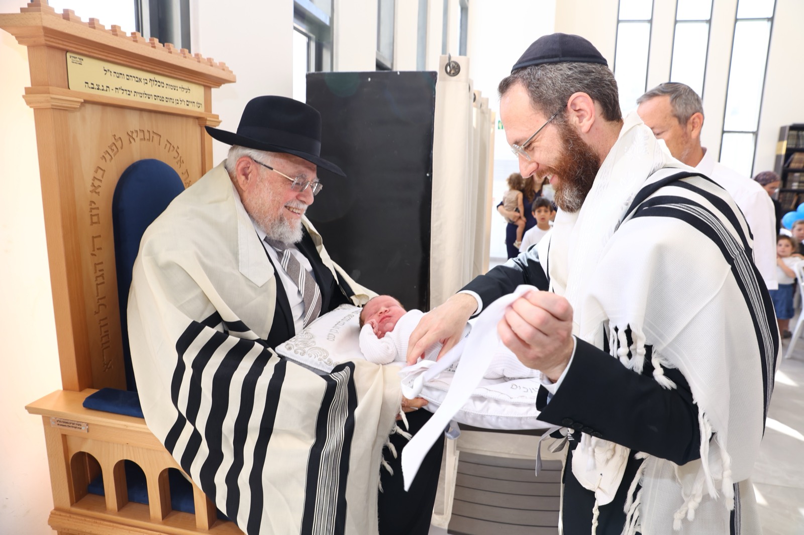Rabbi Grossman with a baby at a bris in Israel